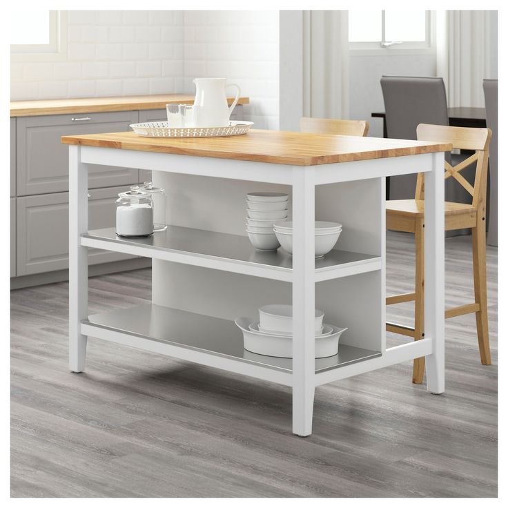 an image of a kitchen island with drawers on the top and bottom shelf in white