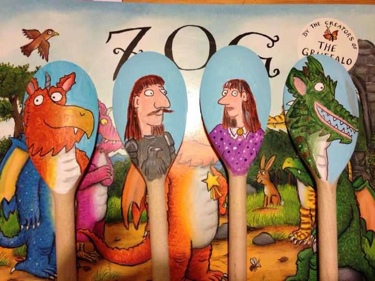 four spoons with cartoon characters on them in front of a book cover that says zoo