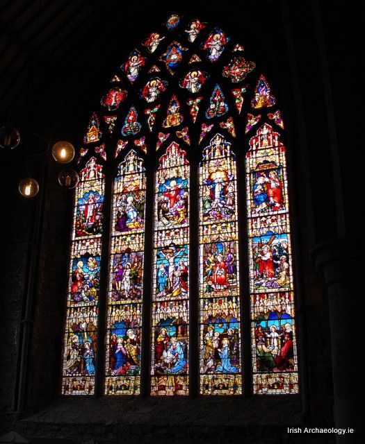 a large stained glass window inside of a church