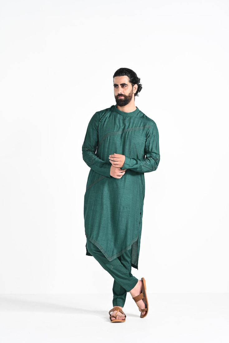 Bottle green criss cross jhaal embroidered on Modal silk with zari stitchline, pintuck and assymetrical hemline kurta. Paired with bottle green slim fit Pant Pajama. Color of the actual garment may vary due to lighting conditions during the shoot.
 

Size Chart For Men





	
	
					Men's Size Chart
		

		
		
						
				Size Chart For Men
				Custom Size Measurement Guide
			
			
				
				
				Custom Size Measurement Guide
1. Take your measurements at ease…don’t hold your breath!
2. Be a little Green Cotton Silk Kurta With Chikankari Embroidery, Designer Unstitched Straight Kurta, Designer Chanderi Kurta For Eid, Transitional Green Chanderi Bandhgala, Green Chanderi Sherwani With Traditional Drape, Cotton Sherwani With Dabka Work For Spring, Green Raw Silk Straight Kurta Bandhgala, Designer Pista Green Kurta For Eid, Green Chanderi Sherwani For Eid