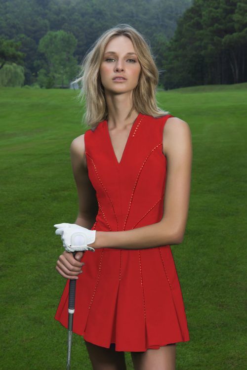 a woman in a red dress holding a golf club