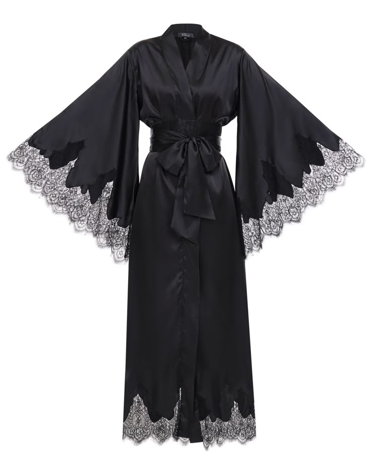 The Audra robe is a sleek, black satin piece with bell sleeves and a hem lined with lace, plus a waist tie for a nice shape. It's a long, luxurious robe that makes every morning special. ✓ garment length - 147 cm/58'' ✓ wrap over style ✓ two sets of inside ties ✓ wide obi-tie is included. Material Composition:  polyamide 60%, viscose 20%, polyester 10%, silk 7%, elastane 3% Model is 175 cm/66.9'' tall and wears size XS/S. Fancy Robe, Black Silk Robe, Fancy Robes, Luxury Robes, Dark Academia Clothes, Academia Clothes, Satin Kimono, Silk Robe, Womens Robes