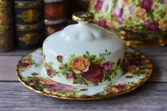 a tea pot and saucer sitting on top of a wooden table