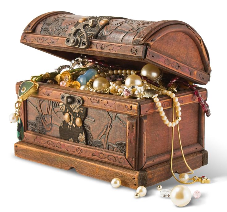 an open wooden chest with pearls and other items in it on a white background,