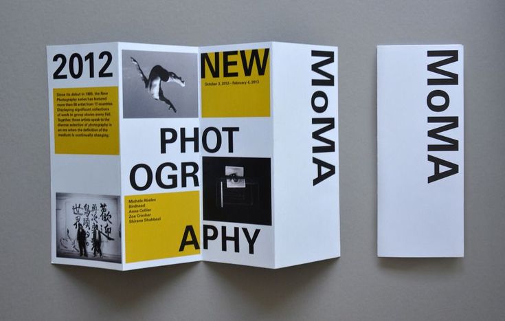 two brochures are displayed on a wall with yellow and black text that reads new photographer aphy