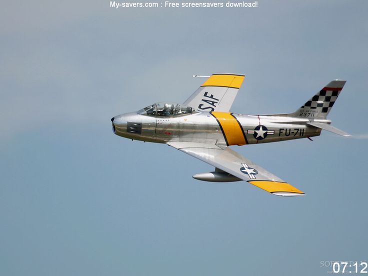 a silver and yellow airplane flying in the sky