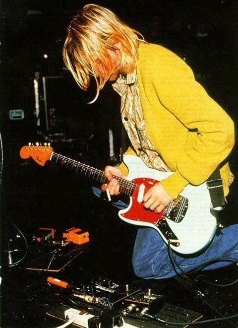 a man playing an electric guitar on stage