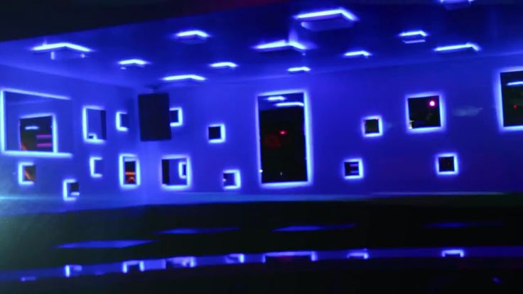 an empty room with blue lights on the walls