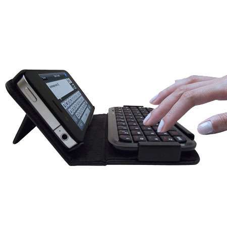 a person typing on a keyboard with their hand holding the key board and mouse attached to it