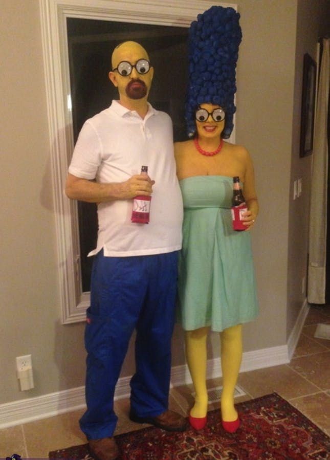 a man and woman dressed up as simpsons and homer from the simpsons show standing next to each other