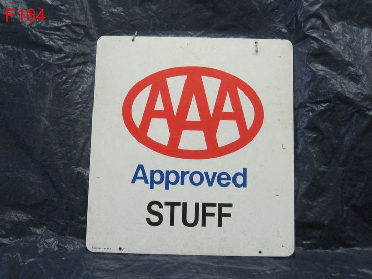 a red and white sign that says approved stuff is on a black plastic sheeted surface