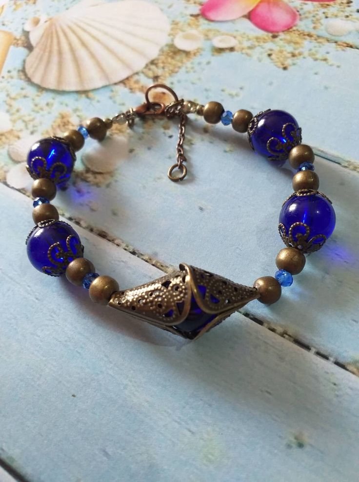 Victorian bronze Royal blue bracelet Boho bracelet Cobalt blue bronze bracelet filigree bracelets Antique style bracelets gift for her Victorian filigree Royal blue glass beads and filigree bronze ornaments. Unique bracelet . Bronze and Cobalt blue  bracelet . Boho bracelet . Bohemian bracelet . Vintage style bracelet. Antique style bracelet. Gothic style bracelet. Perfect Gift .  The bracelet is adjustable with the extra 5 cm chain, so you can fix the length and the size that you want ! FREE SHIPPING  Material :  glass beads , bronze filigree ornaments beads and caps . Length : 6.70+ 2 extra chain( 16 + 5 cm. extra chain) If you have any question, please contact me ! Thank you for visiting my shop ! If you have a RUSH ORDER and you want to pay for FAST SHIPPING by DHL - 3-5 business days Luxury Vintage Blue Bracelet, Elegant Blue Metal Beaded Bracelets, Elegant Blue Beaded Metal Bracelets, Blue Metal Filigree Jewelry, Blue Metal Beaded Bracelets As Gift, Blue Brass Jewelry For Jewelry Making, Blue Metal Bracelets With Round Beads, Handmade Blue Copper Bracelets, Antique Blue Bracelet As Gift