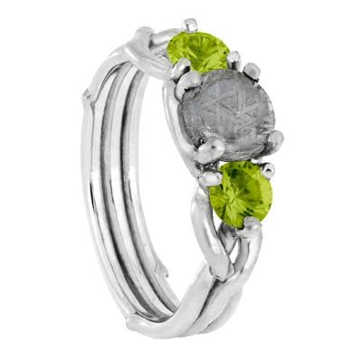 three stone ring set in sterling silver with green cubics and leaves on each side