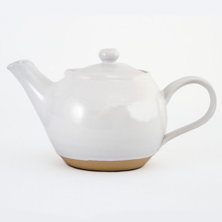 a white teapot with a wooden base on a white background, the top half is empty