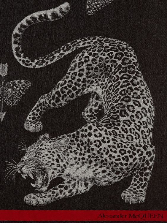 a black and white drawing of a cheetah attacking a butterfly with its mouth open