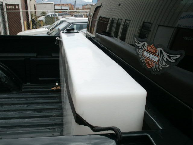 the back end of a truck parked next to other vehicles