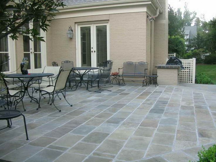 an outdoor patio with chairs and tables