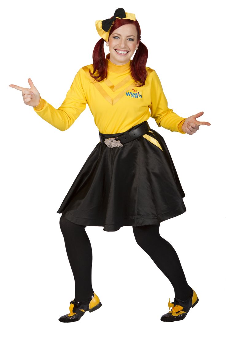 a woman in a yellow shirt and black skirt posing for the camera with her hands out