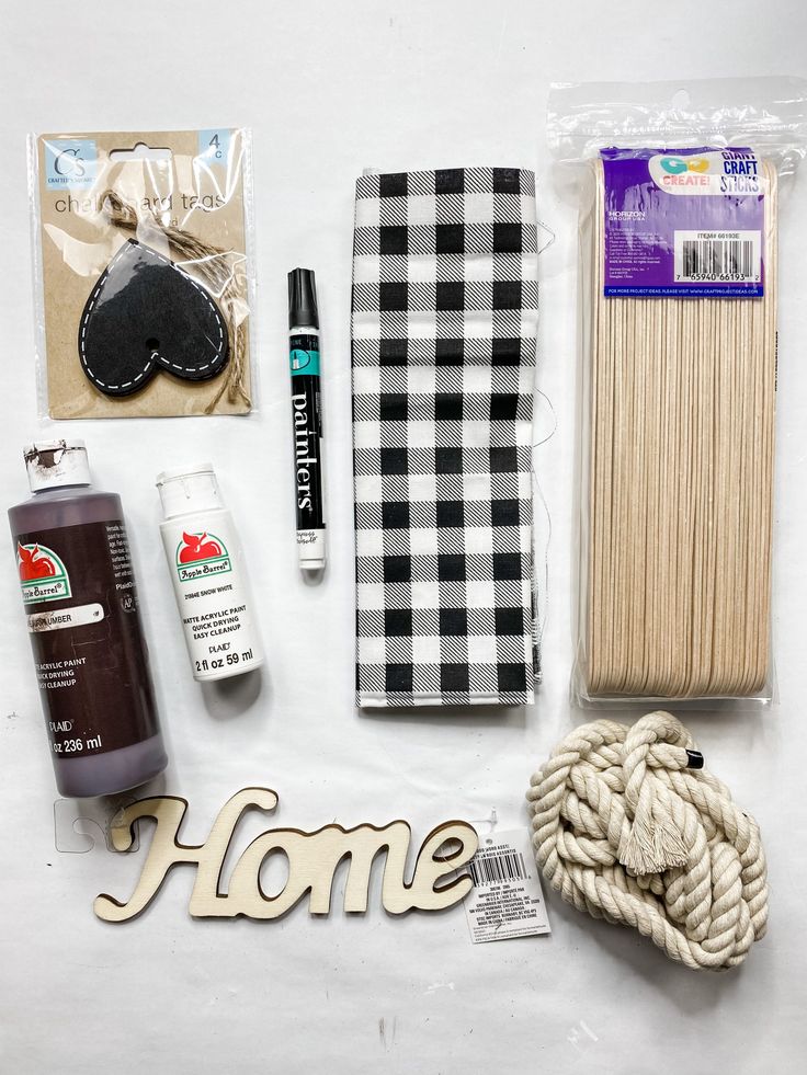 the contents of a craft kit laid out on top of a white sheet with words home