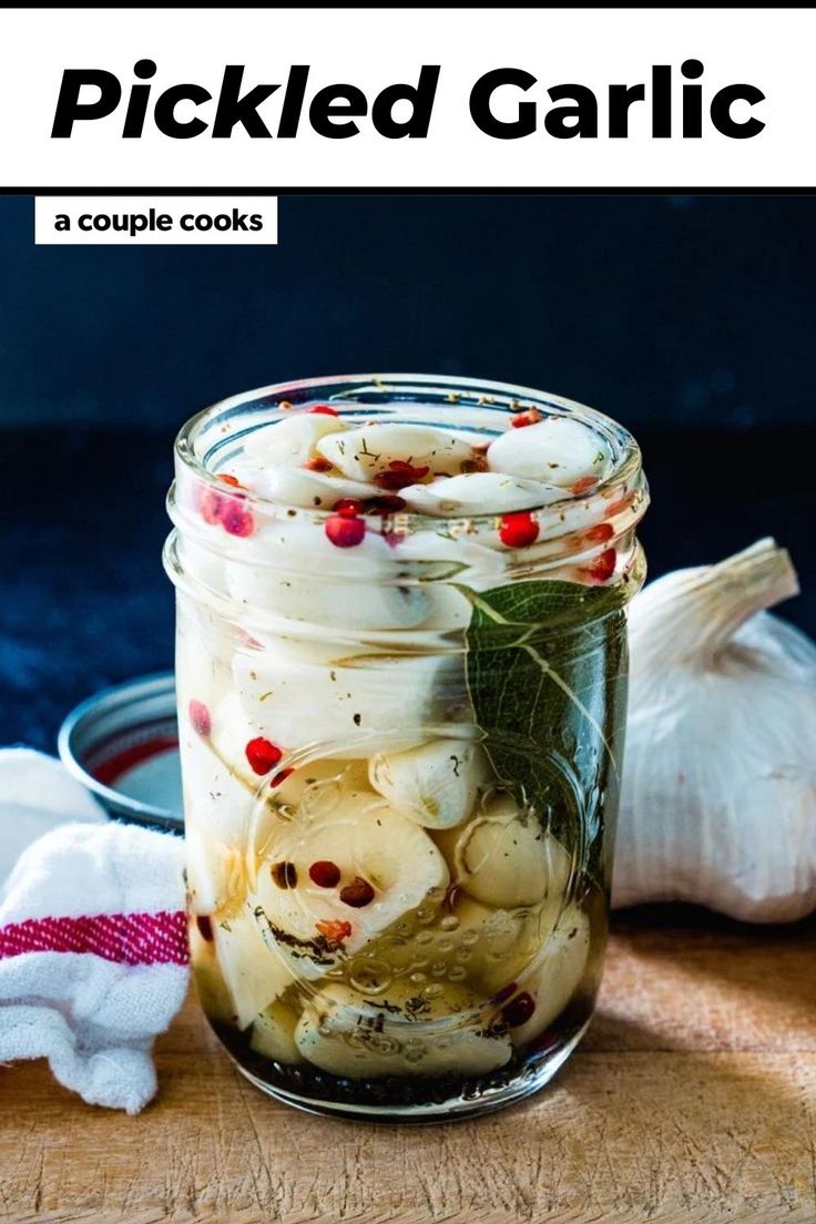 pickled garlic in a mason jar on a cutting board