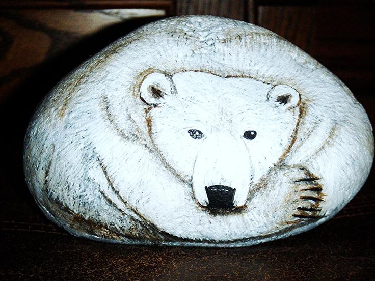 a white bear statue sitting on top of a wooden table