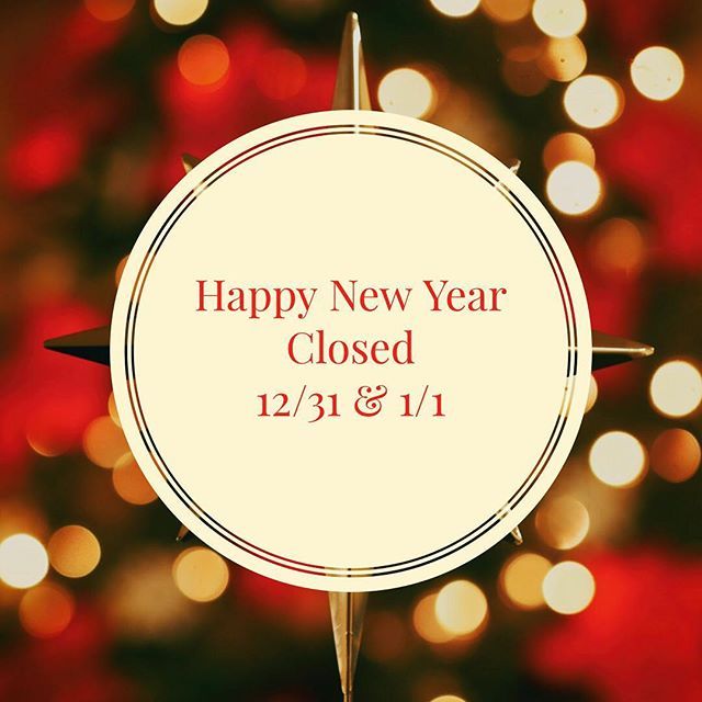 a happy new year closed sign in front of a christmas tree with red and gold lights