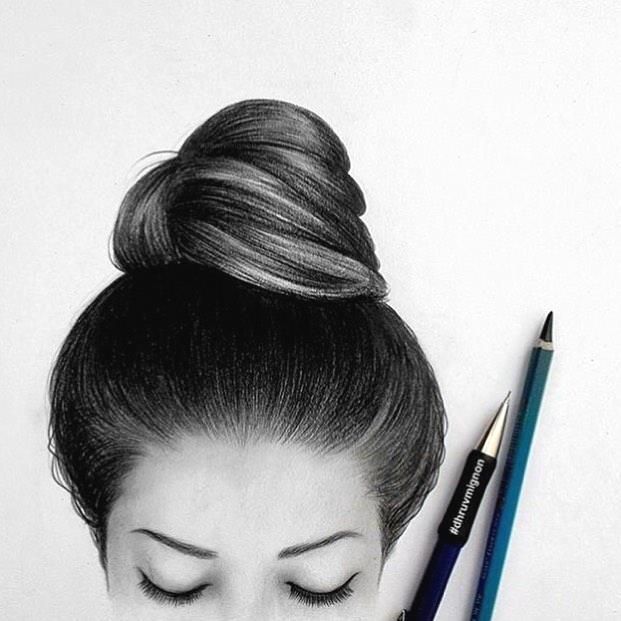 a woman with her eyes closed next to a pencil