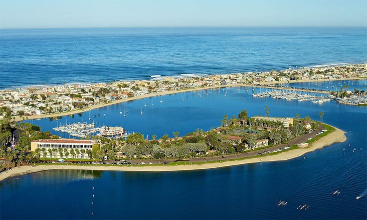 an aerial view of a marina with boats in the water and buildings on the shore