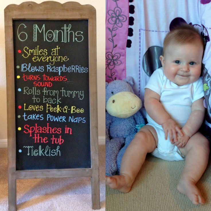 a baby sitting in front of a chalkboard with the words 6 months written on it