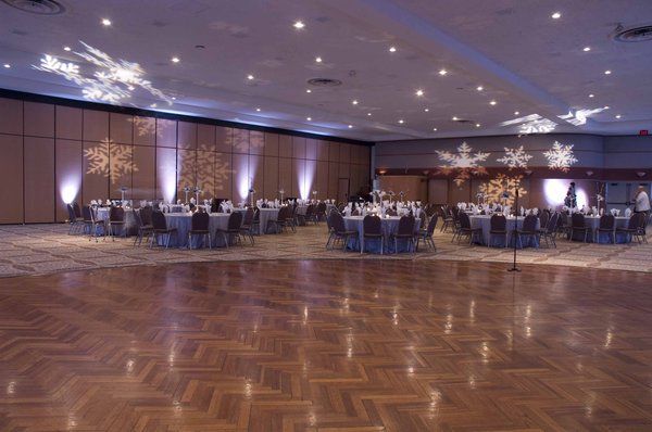 an empty ballroom with tables and chairs set up