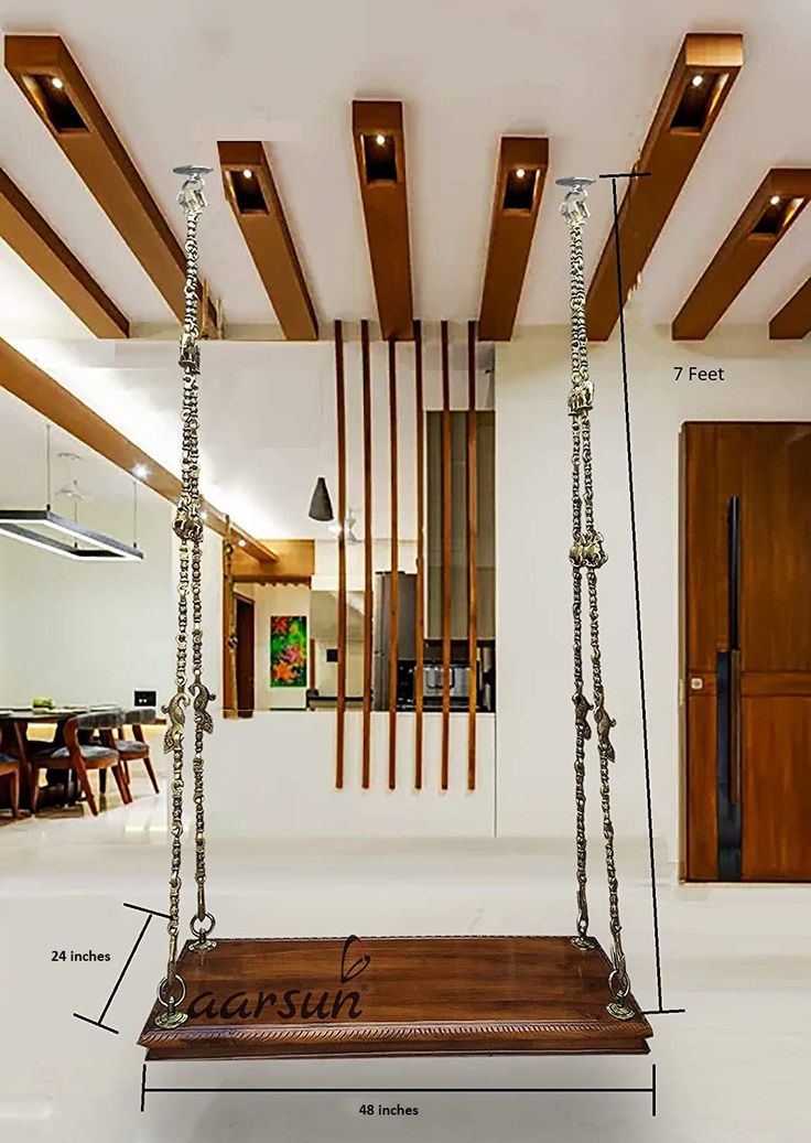 a wooden swing hanging from the ceiling in a living room