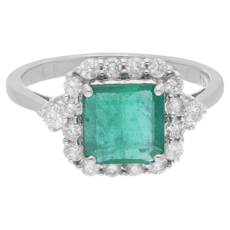 Immerse yourself in the enchanting beauty of this Zambian Emerald Gemstone Ring, an exquisite piece of handmade fine jewelry meticulously crafted in luxurious 18 Karat White Gold. Radiating elegance and sophistication, this ring is adorned with stunning diamonds, perfectly complementing the allure of the majestic emerald centerpiece. The ring is a size 7 US and may be resized to larger or smaller upon request. FOLLOW SPECTRUM JEWELS storefront to view the latest collection & exclusive pieces. Sp Luxury Cluster Diamond Ring With Gemstone, Elegant Green Diamond Gemstones, Luxury White Gold Gia Certified Gemstones, Luxury Gia Certified White Gold Gemstones, Luxury Emerald Gemstones With Accent Stones, Elegant Green Gia Certified Gemstones, Elegant Gia Certified Cubic Zirconia Cluster Ring, Elegant Cubic Zirconia Cluster Ring Gia Certified, White Gold Gemstones With Halo Setting Fine Jewelry