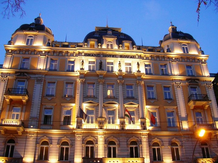 a large building lit up at night with lights on