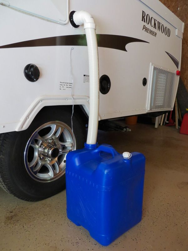 a blue container is next to a white truck