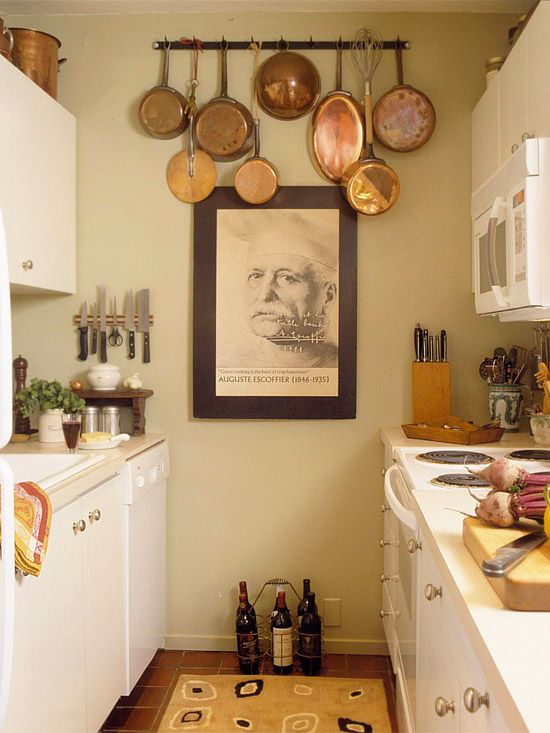 a kitchen with pots and pans hanging on the wall