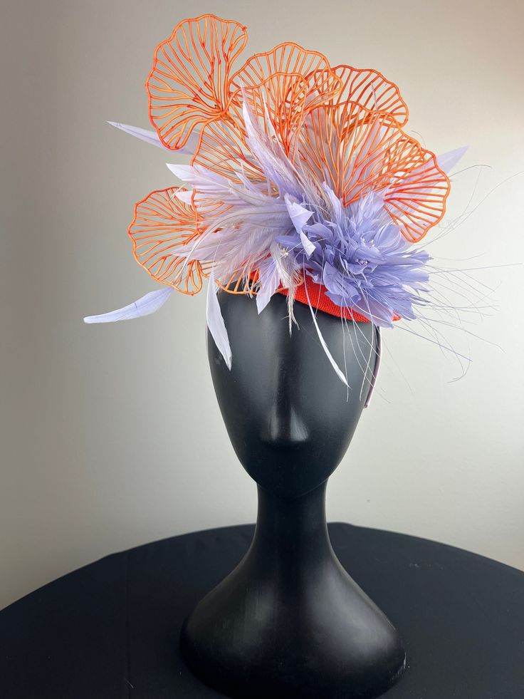 An orange button base topped with a beautiful lilac feather crown and feather flower, piled high with sculptural gingko leaves. Sits on a comfortable lilac headband. Ships in a high quality storage box. One of a kind. Perfect for Kentucky Derby, Royal Ascot, church, weddings, just for fun. Feather Crown, Gingko Leaves, Church Weddings, Feather Fascinator, Feather Fascinators, Feather Flower, Royal Ascot, Louisville Ky, Kentucky Derby