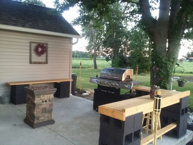 an outdoor bbq and grill in the back yard