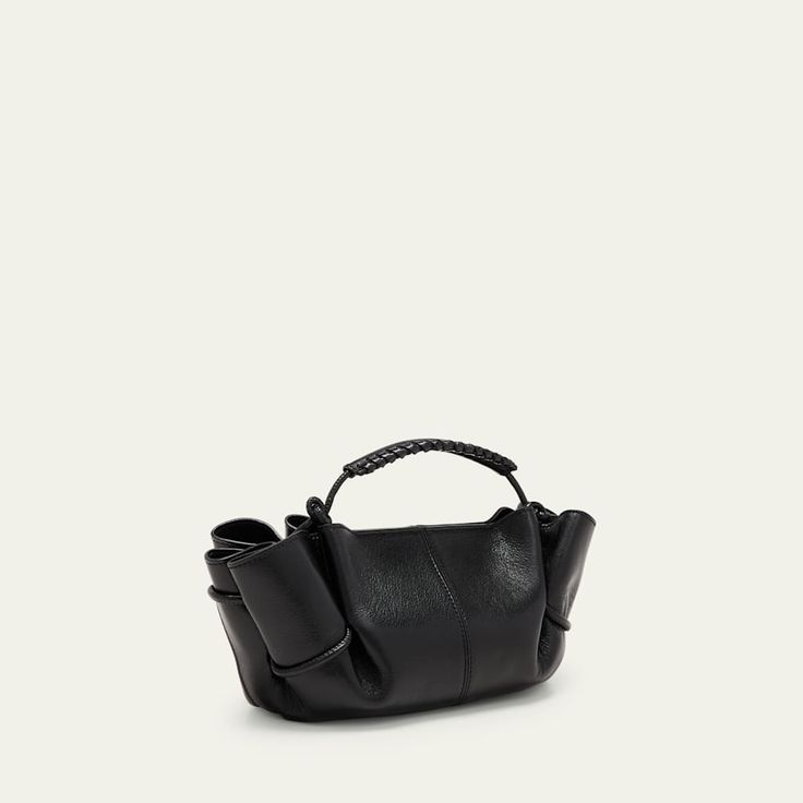 HEREU "Arta" top handle bag in leather  Top handle  Adjustable crossbody strap, 47.2"L Can be worn as a top handle or crossbody bag  Open top with magnetic closure  Approx. 7.1"H x 7.9"W x 6.7"D Item Weight (Lbs.): 1.1 Made in Spain Designer Top Handle Satchel With Rolled Handles, Leather Top Handle Bucket Bag, Leather Satchel With Rolled Handles For Evening, Office Shoulder Bag With Top Handle And Rolled Handles, Luxury Evening Satchel With Rolled Handles, Office Shoulder Bag With Rolled Top Handle, Office Satchel With Top Handle And Rolled Handles, Evening Satchel With Rolled Handles In Tote Shape, Modern Shoulder Bag With Rolled Top Handle