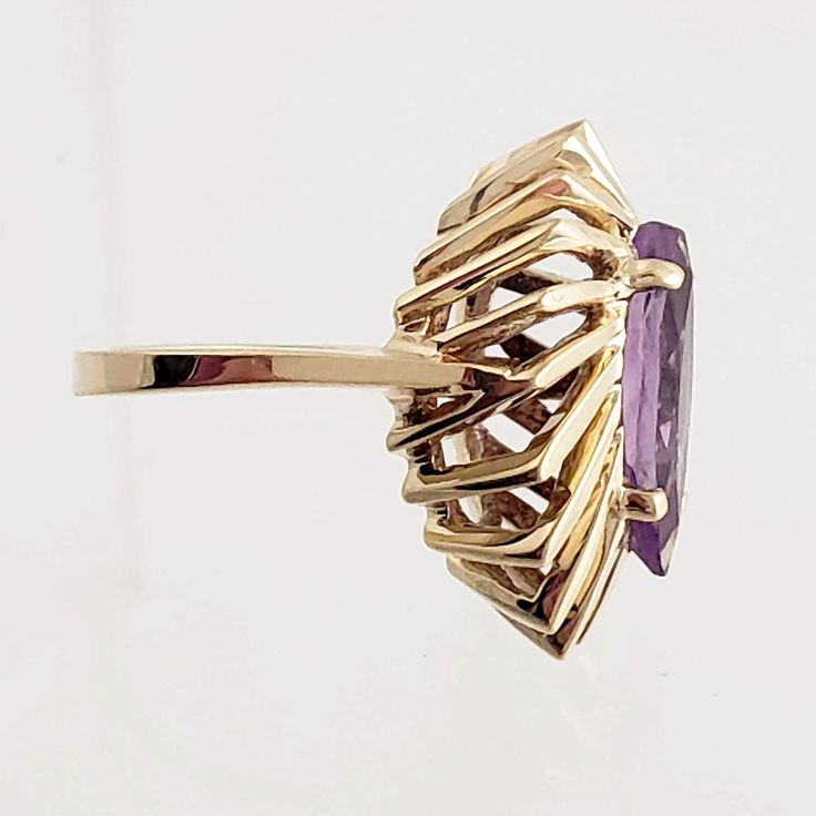 "A stand-out cocktail ring! This vintage 10K gold ring features a large marquise cut amethyst. The gemstone is set atop a dynamic, angular basket which gives this unique ring dimension. Vintage: 1970s Size: 6 on the tight side Materials: 10K Yellow Gold, Amethyst Marked: LOREN 10K Amethyst: marquise cut, approx. 15mm x 7.5mm Width North to South: 7/8\" Width East to West: 5/8\" Stands Off Finger: 3/8\" Shank Width: just over 1/16\" Weight: 4.2 dwt / 6.5 g / .21 ozt Condition: Excellent FREE PRIO Heirloom Marquise Amethyst Ring For Anniversary, Marquise Amethyst Anniversary Ring, Marquise Amethyst Ring For Anniversary, Elegant Marquise Amethyst Ring With Prong Setting, Gold Marquise Amethyst Gemstone Ring, Gold Amethyst Marquise Ring, Formal Gold Marquise Cut Amethyst Ring, Yellow Gold Marquise Amethyst Ring For Anniversary, Luxury Marquise Cut Amethyst Ring