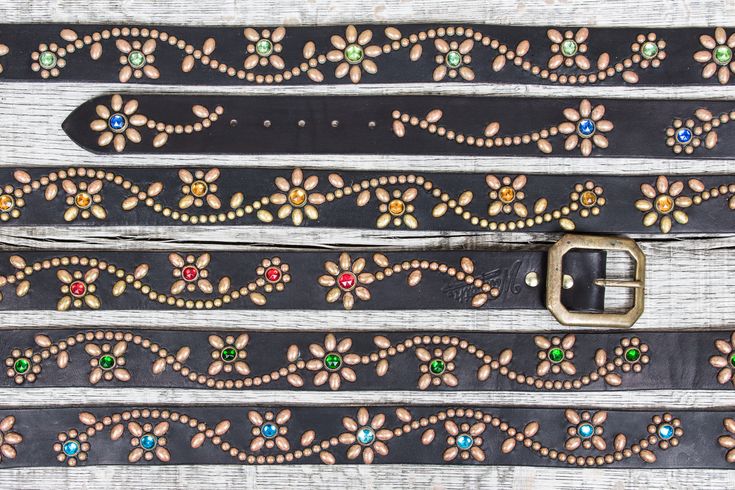 two belts with different colored stones on them