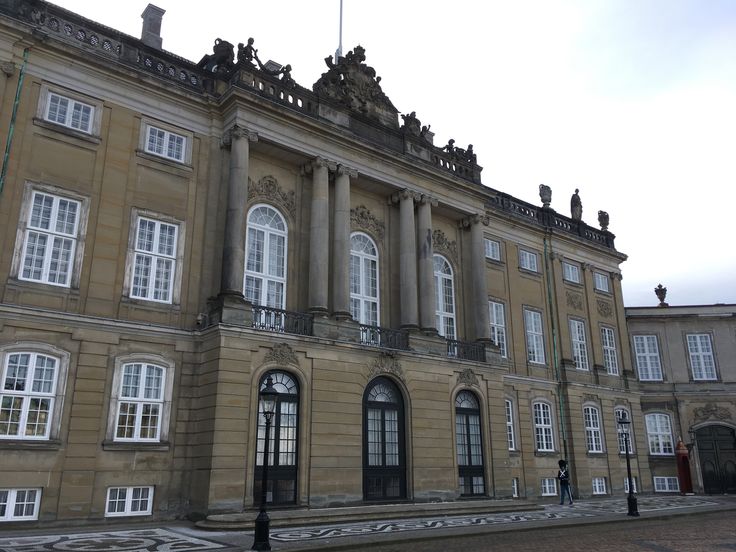 an old building with many windows and statues on top