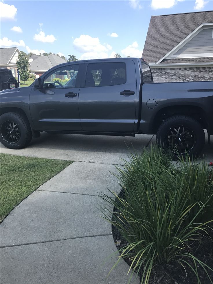 a gray truck parked in front of a house