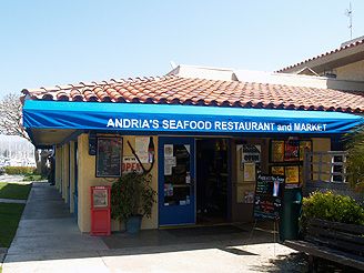 an outdoor seafood restaurant with blue awning