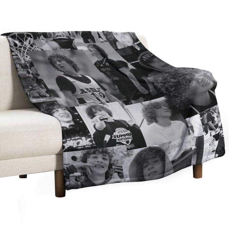 a couch with a blanket that has photos on it and people all over the place