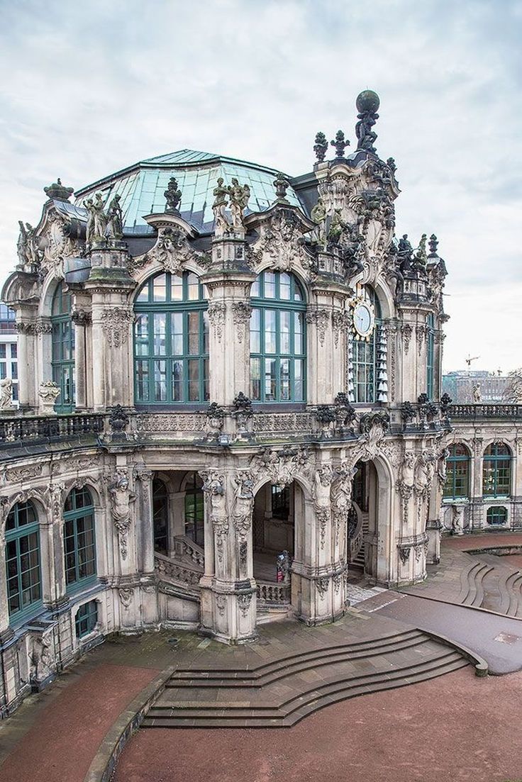 an old building with many windows and steps leading up to the top floor in front of it