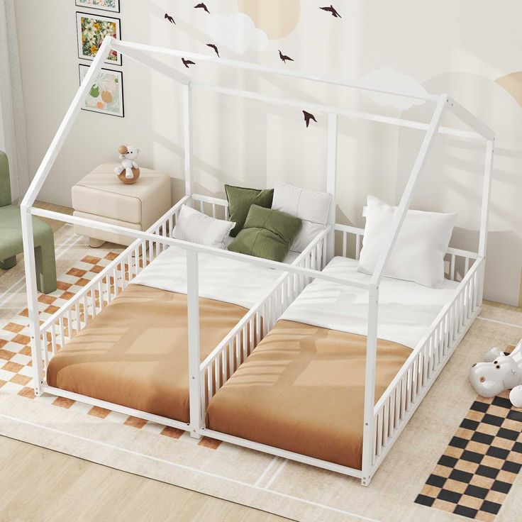 a white bed frame with two beds underneath it