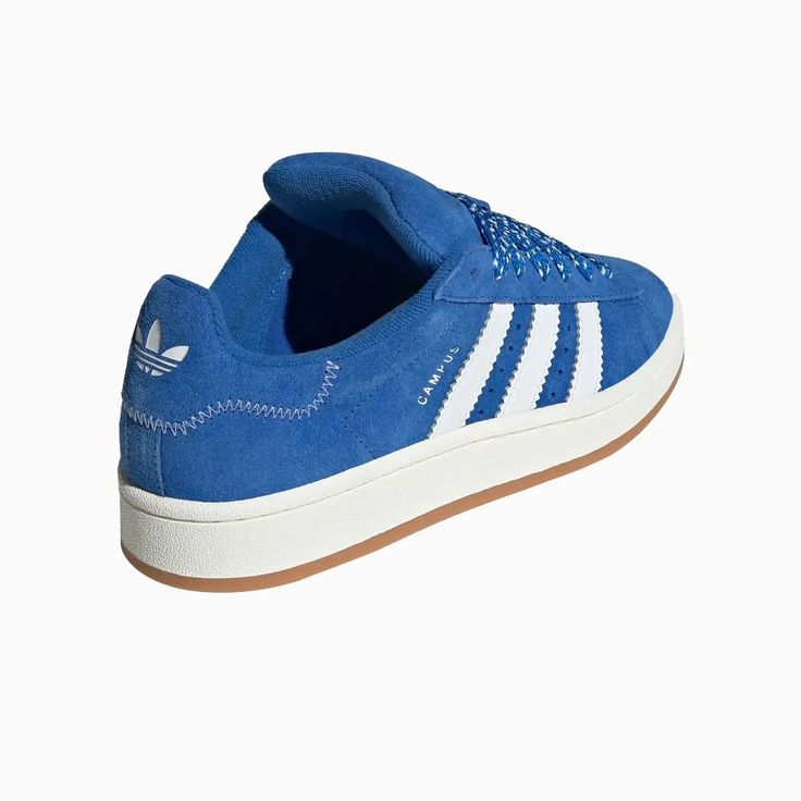 Campus 00s ShoesClassic shoes with a 2000s skate-inspired look.Step out in style in these adidas Campus 00s Shoes. Heavily influenced by the 2000s skate era, these shoes take the iconic look of the classic Campus 80s and update it with bold new proportions. The suede and leather upper pairs with a gum rubber outsole for instantly recognisable heritage style. Contemporary touches come in the form of oversized 3-Stripes and wide printed laces. A perfect blend of old and new, these shoes make a sta Blue Campus, Campus 00s Shoes, 00s Shoes, Adidas Campus 00s, Sneakers Adidas, Adidas Campus, Heritage Fashion, The 2000s, Shoes Sneakers Adidas