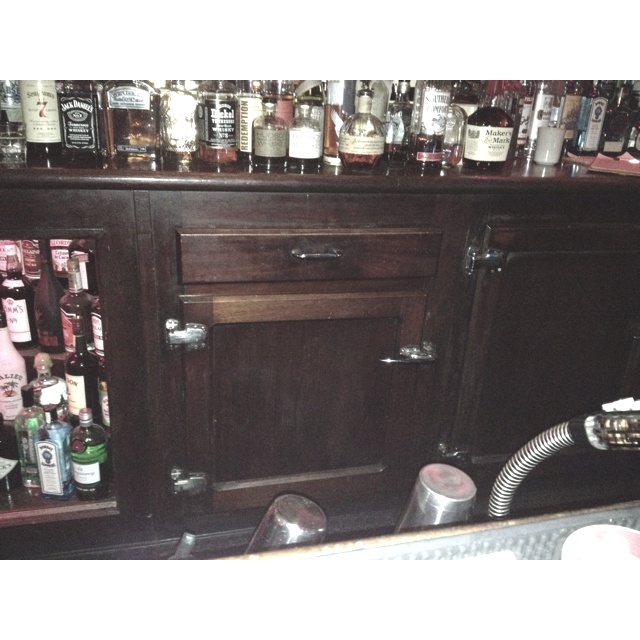 an old fashioned bar with liquor bottles on it