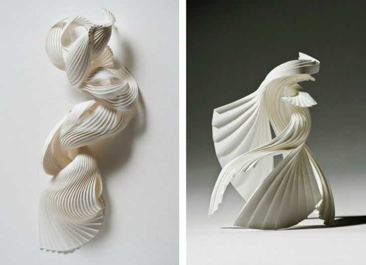 two different sculptures made out of paper on the left and right, one is white