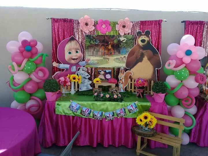 there is a table with balloons, flowers and stuffed animals in the middle of it